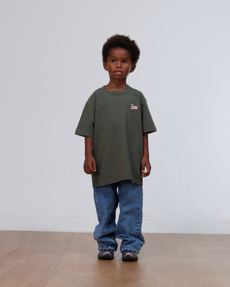 Front full-length view of a young boy wearing the climbing ivy green Patta Kids Charm T-Shirt.